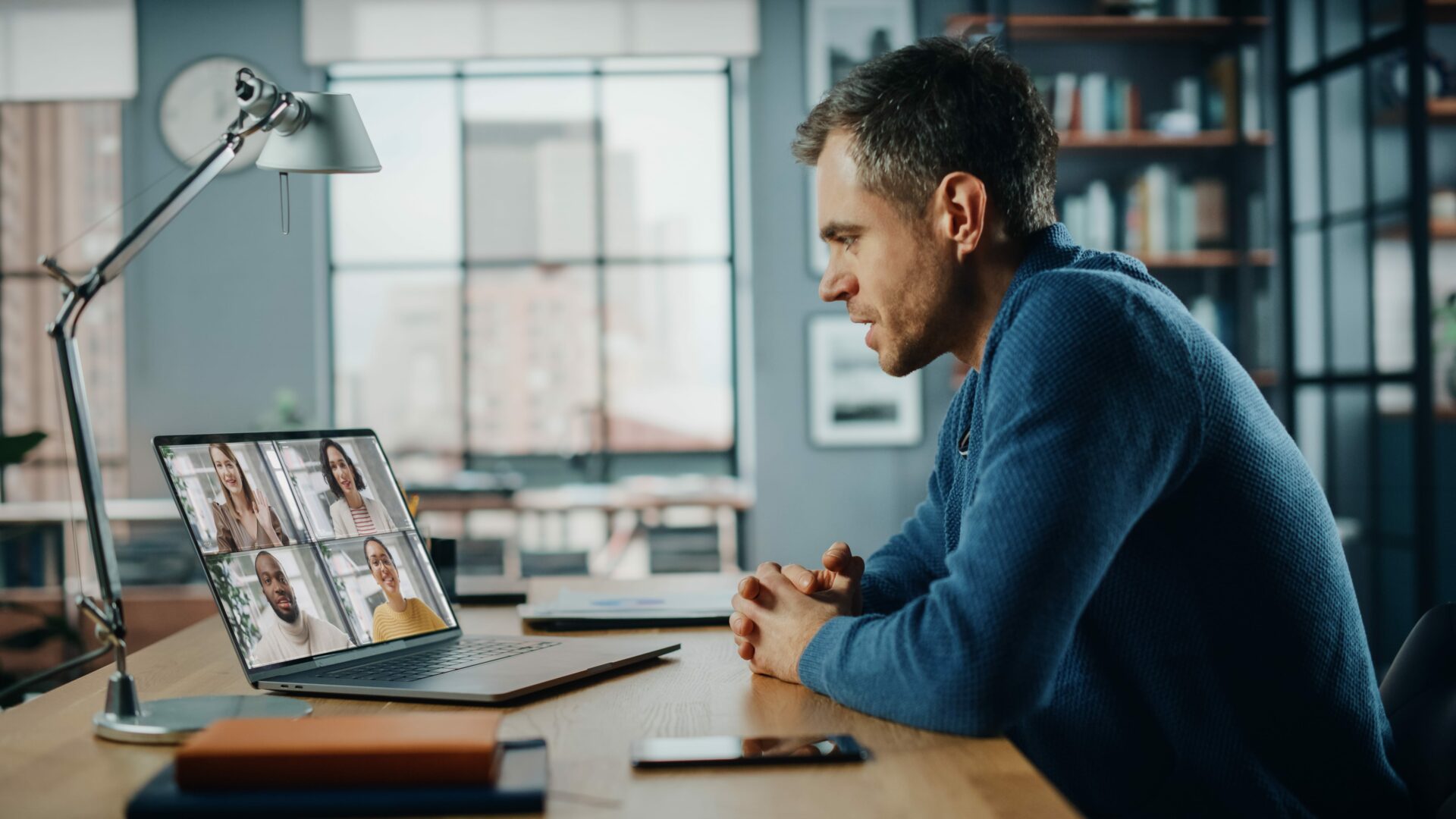Handsome caucasian man having a video call on laptop computer wh